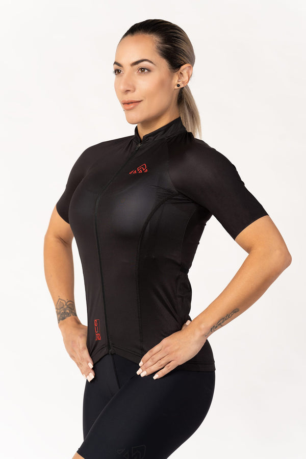   A close-up of a women's cycling top with short sleeves. The jersey features a vibrant color and a sleek design, perfect for female cyclists.