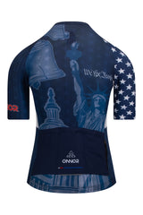 Rear view of the Women's American Pride 2023 Elite Cycling Jersey Short Sleeve by ONNOR in blue and red, featuring the United States flag. The picture underlines the jersey's practical rear pockets and safety-enhancing reflective details, highlighting ONNOR's commitment to combining utility, safety, and patriotic style in a top-tier cycling garment.