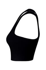 Pure side profile of a black women's athletic top with champagne logo detailing, set against a stark white background to emphasize the silhouette.