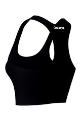 Women's black fitness top with champagne logos, captured from a back-side angle, showcasing the design's curvature on a white background.