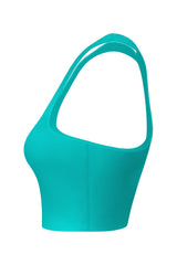 Side profile of a jade green women's sports top featuring mint logos, presented against a white background to focus on the garment's cut and fit.