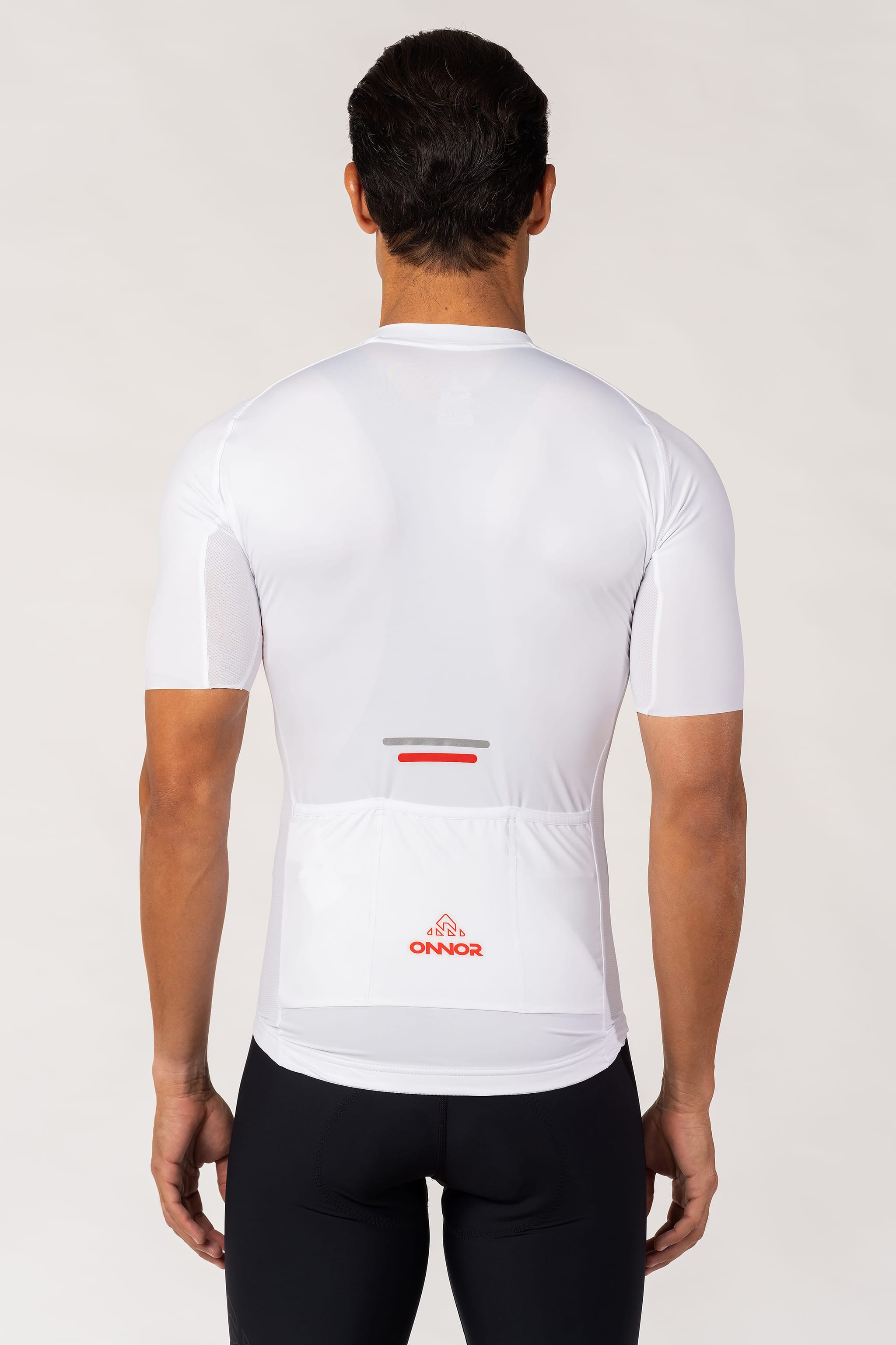 A man wearing a masculine cycling jersey with short sleeves. The men's mountain biking jersey is designed to offer a stylish look and superior performance on off-road adventures.