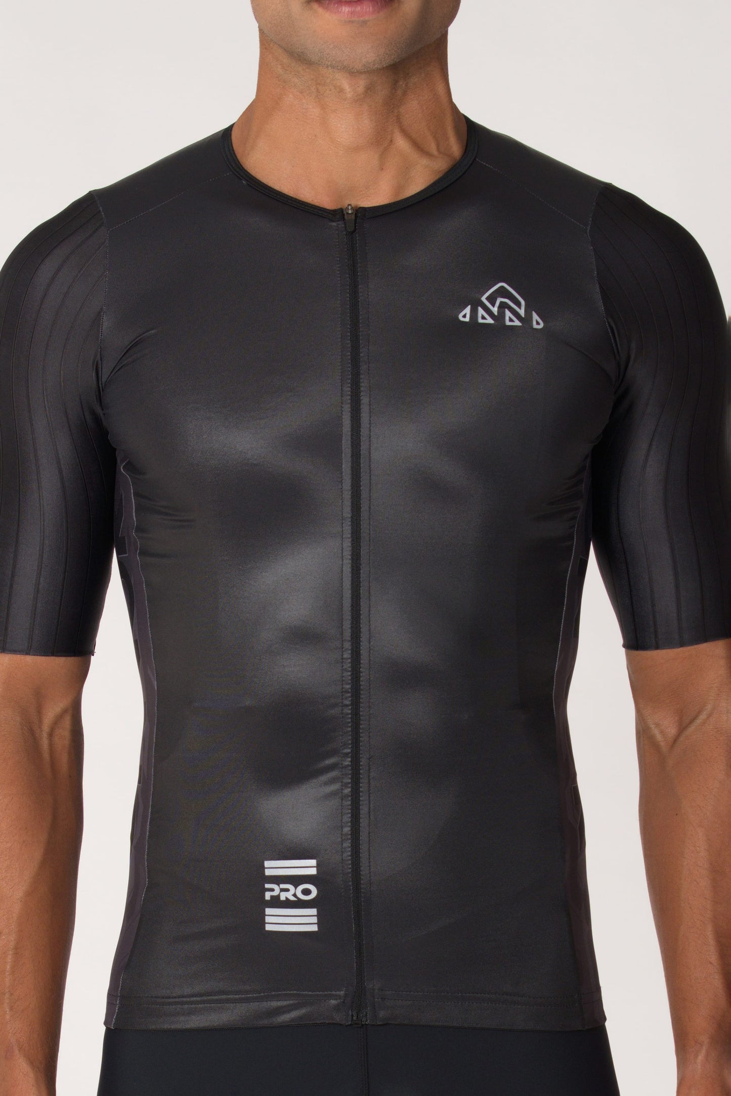A man wearing a stylish and comfortable bike shirt with short sleeves. This masculine cycling jersey is designed to provide a perfect fit and enhance the cyclist's experience.