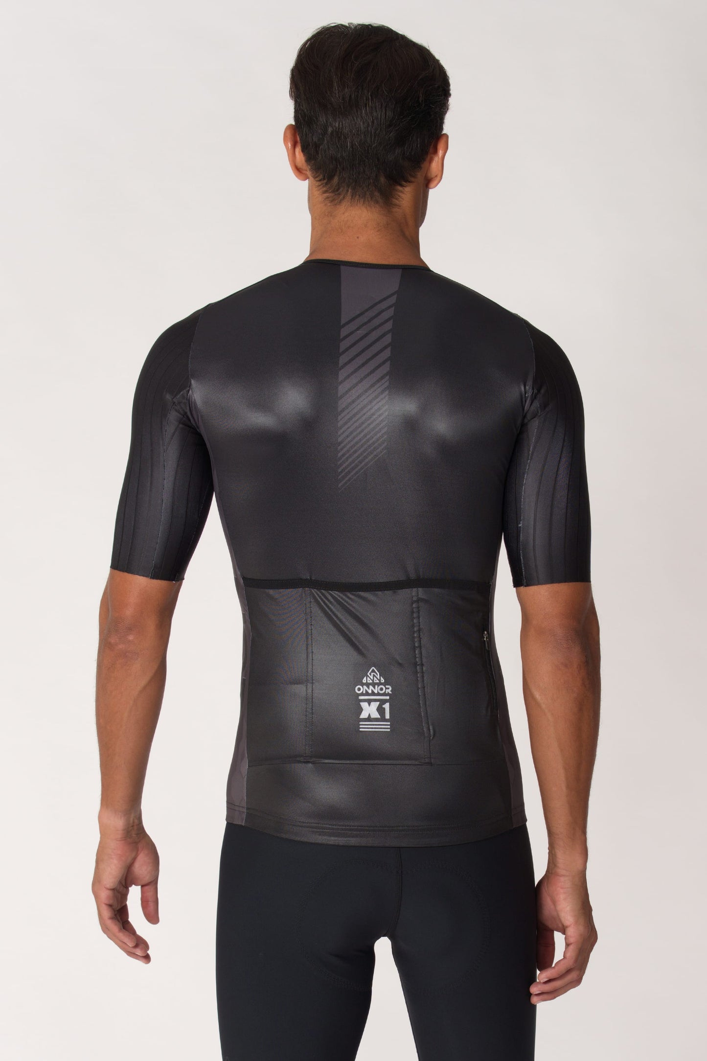 A close-up of a men's bicycle jersey with short sleeves. This short-sleeved gentlemen's cycling top offers a sleek and aerodynamic design, ensuring maximum performance on the road.