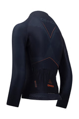 A professional female rider sporting a long-sleeved women's cycling shirt. The jersey has extended sleeves, ensuring full arm coverage and protection. It is designed for women cyclists and features a tailored fit. This women's cycling top is specially crafted for cooler weather and provides optimal comfort and style.