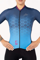 A short-sleeved jersey for women cyclists. The jersey features a bold color block design with contrasting panels. It has a slim fit and is made of a moisture-wicking fabric, keeping the cyclist dry and comfortable throughout the ride.